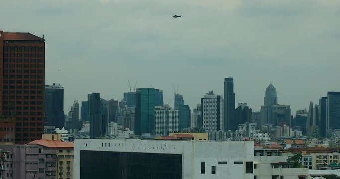Royal Thai Military Helicopter Flying Over Bangkok City Skyline, Thailand in True 4K DCI.