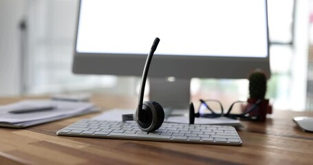 Call center operator headset glasses keyboard and monitor at workplace of support service employee. Effective remote assistance and support