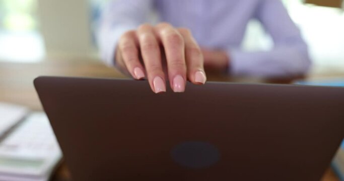 Manager opens laptop and starts typing on computer keyboard. Start of working day and search for information on Internet