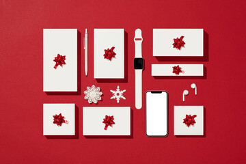 Smart phone mockup, template on Christmas concept red background with white gift boxes
