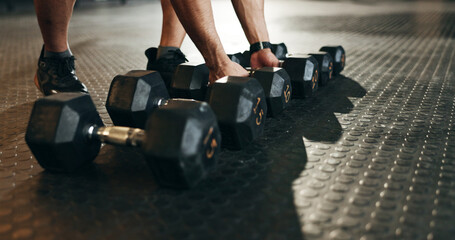 Fitness, athlete and closeup of dumbbells in gym for exercise, workout and sports training. Hands...
