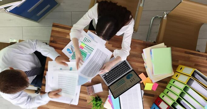 Happy colleagues business people with documents having fun at meeting working top view. Businesswoman discussing business documents at meeting with client client in office