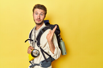 Fototapeta na wymiar Traveler with mountain backpack and torch surprised and shocked.