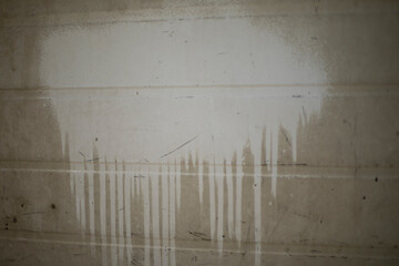 Stain on the wall. Paint was dripping down the wall. White stain from paint.