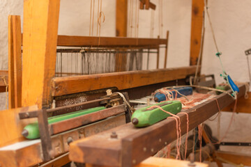 Obraz na płótnie Canvas An old loom with threads placed ready to create fabrics