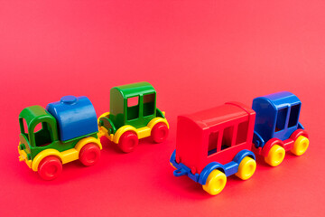 Children's toy, a multi-colored steam locomotive on a rede background.