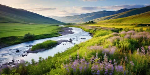 Zelfklevend Fotobehang A bubbling stream winds its way through a lush valley surrounded by rolling hills blanketed in wildflowers. Generative AI © piai