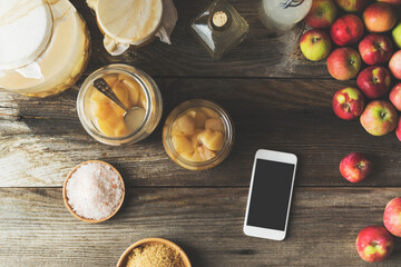 Making homemade apple cider vinegar, smartphone on the table
