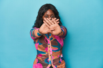 Young african american curvy woman doing a denial gesture