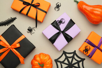 Happy Halloween holiday concept. Flat lay gift boxes, orange pumpkins, bats, spiders on grey...