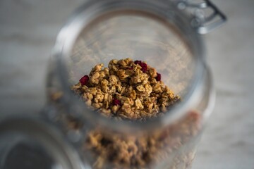 Granola in a jar. Homemade muesli with raspberries. Healthy eating concept