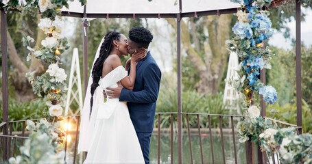 Wedding, dance and kiss, black couple in garden with love, celebration and excited for future together. Gazebo, man and woman at marriage reception with flowers, music and happiness at outdoor party