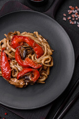 Delicious asian udon dish with vegetables, mushrooms, salt and spices