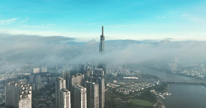 Aerial view of the top of the tallest skyscraper in Ho Chi Minh City on a foggy winter day. Cityscape in Ho Chi Minh City, Vietnam