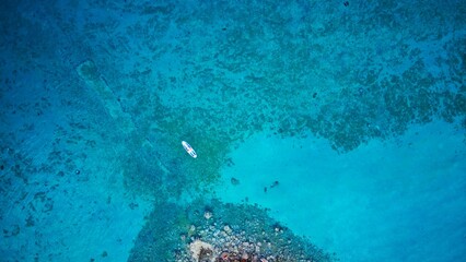 Aerial view of a person enjoying a peaceful paddle boarding on Pag Island, Croatia