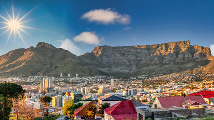 table mountain in cape town, aerial view over residential neighborhood, at sunset