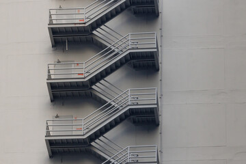 fire escape stair steel. grey outdoor metal stair of the high building. - obrazy, fototapety, plakaty