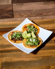 Mexican tacos with sauce served on a white plate