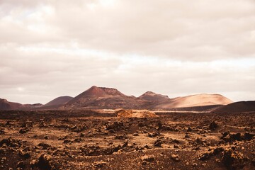 Landscape view of the Volcanic vineyards with hills and mountains in the background