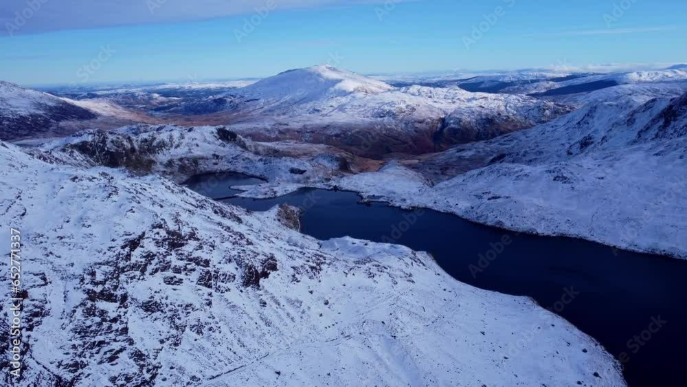 Wall mural Aerial view of beautiful snow-covered mountains and a river.