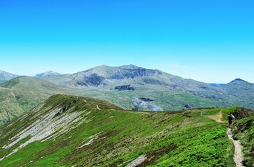 Beautiful view of a person hiking up to a valley in the mountains