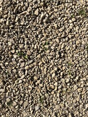 Gray small rocks ground texture. Black small road stone background.  Stone seamless texture. 