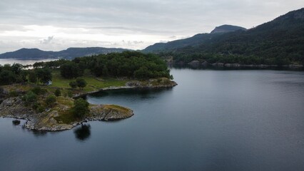 aerial view of a tranquil lake surrounded by lush green mountains in West Norway