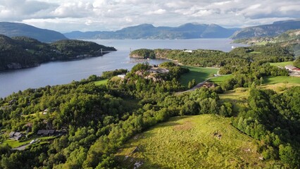 aerial view of a tranquil lake surrounded by lush green mountains in West Norway