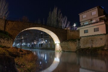 Roman bridge in the town of Trillo at night. Guadalajara. Spain