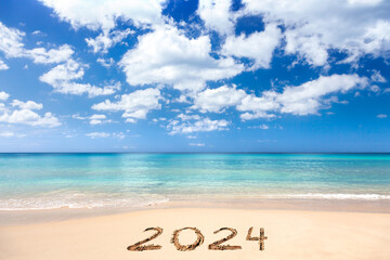 2024 written on sandy beach - 652779949