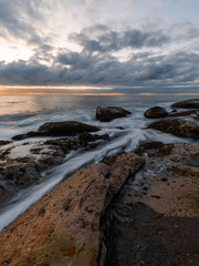 Water flowing on the rock platform on the coastline.