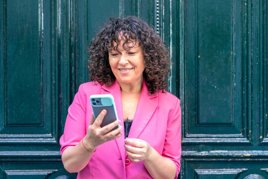cosmopolitan woman consulting her smartphone