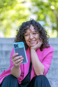 cosmopolitan woman making a video call from her smartphone