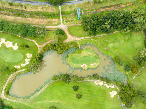 Aerial view drone shot of beautiful green golf field fairway and putting green,Top down image for sport background and travel background