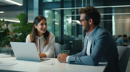 Fototapeta premium Two business people working in team, woman and man working using digital tablet and discussing financial market data, standing at corporate office meeting