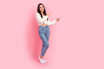 Full length photo of sweet shiny lady wear white cardigan showing two fingers empty space isolated pink color background