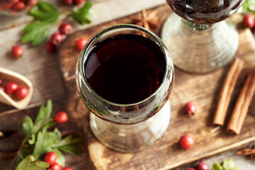 Medicinal wine made of hawthorn berries in vintage glass cups