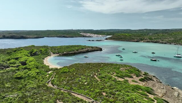 Aerial majesty of Es Grau's coastal enclave and lush surroundings.
