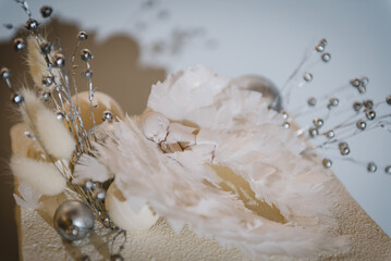 Details trendy cake with figure newborn, wings angel and silver decor. Celebration baptism concept....