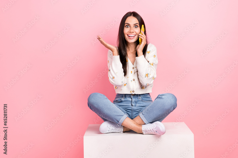 Sticker Full length photo of cheerful impressed lady wear white cardigan speaking modern device empty space isolated pink color background