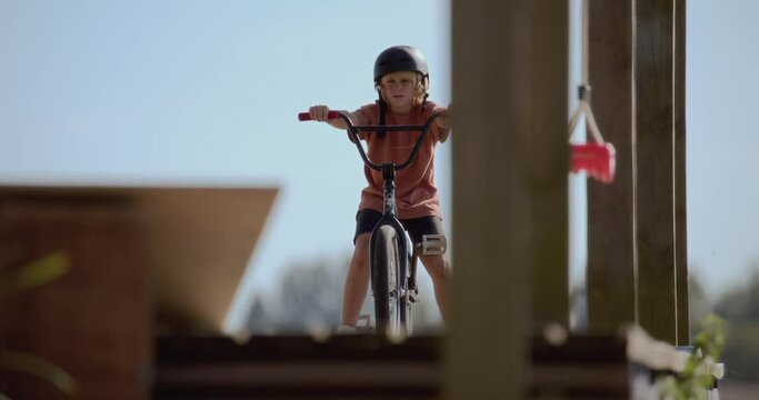 Caucasian kid boy preparing to do a crazy trick on a homemade trampoline