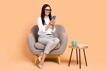 Full length portrait of elegant corporate girl sit comfort soft chair use smart phone chatting...