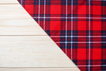 Obraz premium Red Checkered napkin on wooden background