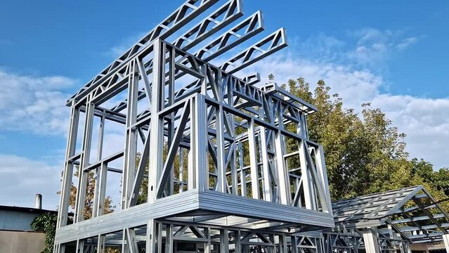 Lightweight steel thin-walled structures. Frames for warehouses, garages or houses. Structure of a steel frame for construction against the sky