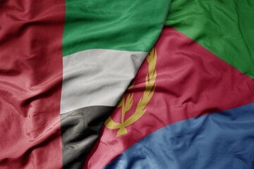 big waving realistic national colorful flag of united arab emirates and national flag of eritrea .