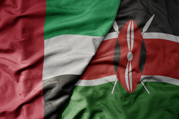 big waving realistic national colorful flag of united arab emirates and national flag of kenya .