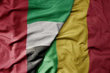 big waving realistic national colorful flag of united arab emirates and national flag of mali .