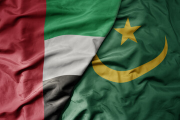 big waving realistic national colorful flag of united arab emirates and national flag of mauritania .