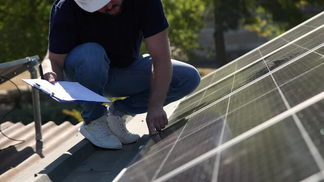 Closeup, hands and man checking solar panels, maintenance and engineer with sustainability. Male person, technician and worker with construction, completed job or inspect quality for renewable energy