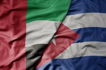 big waving realistic national colorful flag of united arab emirates and national flag of cuba .